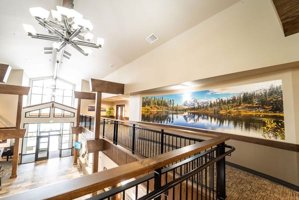 Interior view of a senior care facility with a nature mural