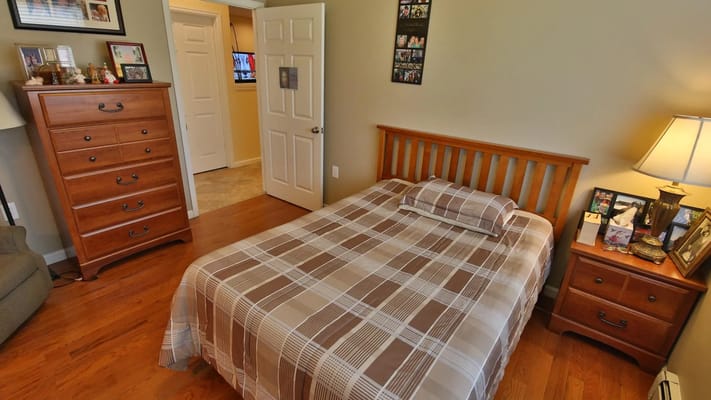 Cozy private resident room with a bed and furniture