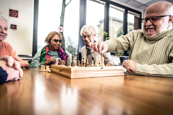 Residents enjoying a game of chess in a common area