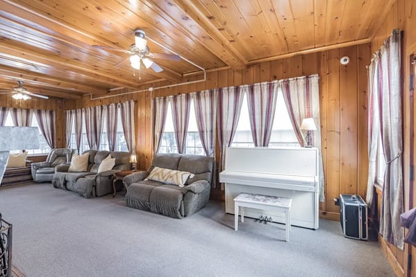 Cozy common area with seating and a piano