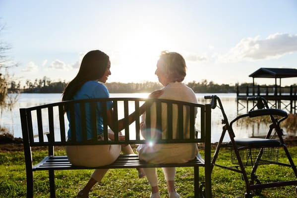 Caregiver and resident enjoying the view by the lake