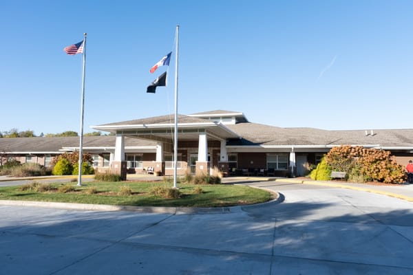 Exterior of Addington Place of Des Moines with flags