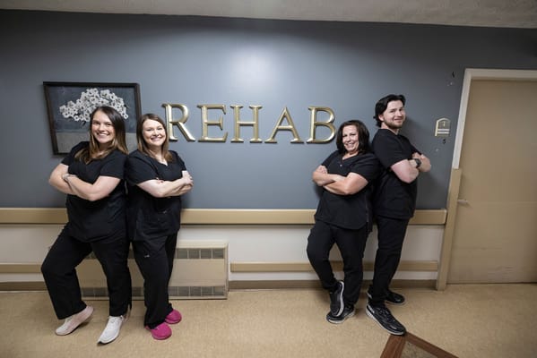Staff members posing in the rehabilitation area