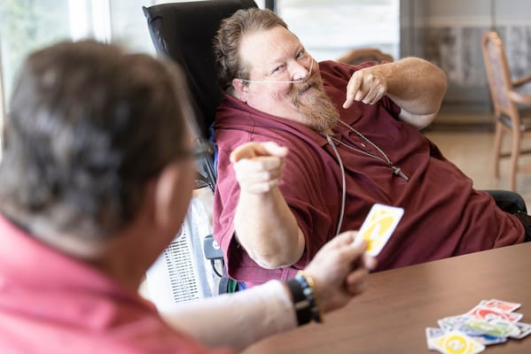 Residents enjoying a game of cards in a communal area