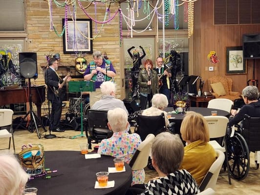 Residents enjoying a live music performance with a band in the background.