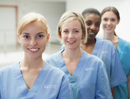 Four staff members smiling in scrubs