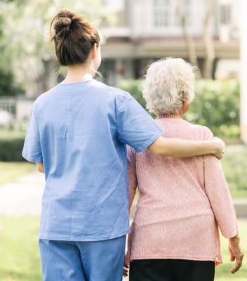 Staff member assisting a resident outdoors