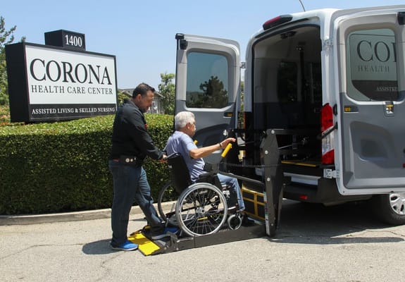 Resident being assisted into a transport vehicle