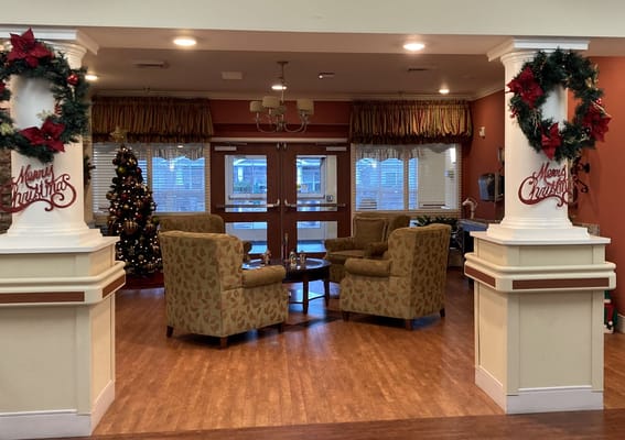 Holiday-decorated lobby with seating at Liberty Commons.