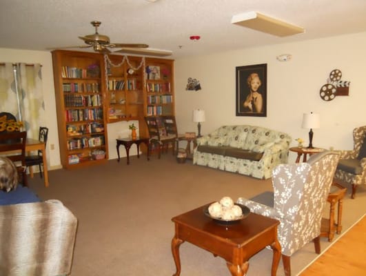 Spacious living room with bookshelves and comfortable seating