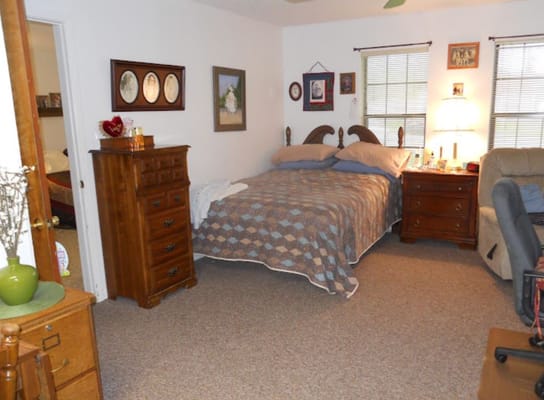 A cozy bedroom with a double bed and wooden furniture.