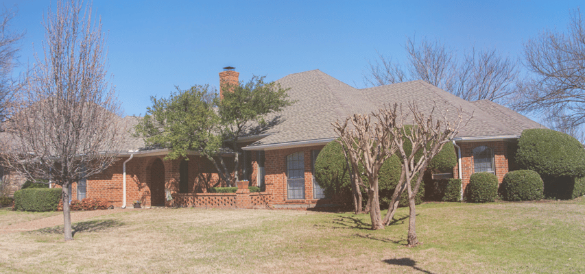 Exterior view of a senior living facility with landscaped grounds
