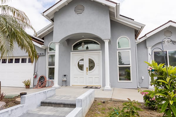 Entrance of a senior care facility with landscaped front yard