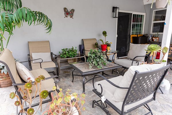 Outdoor seating area with plants and furniture