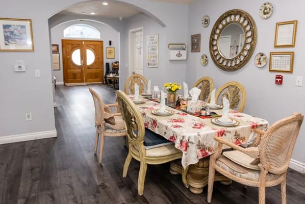 Dining table set with decorative flowers in a facility interior