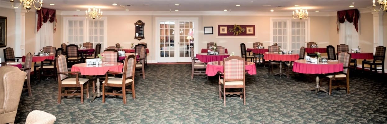 Dining area with tables and chairs set up for meals