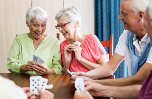 Residents engaged in a lively card game