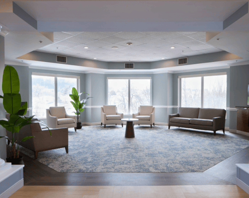 Bright, spacious common area with seating and large windows