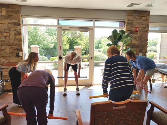 Residents participating in a group exercise activity indoors