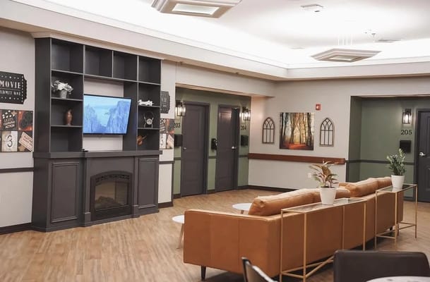 Bright common area with seating and wall decor