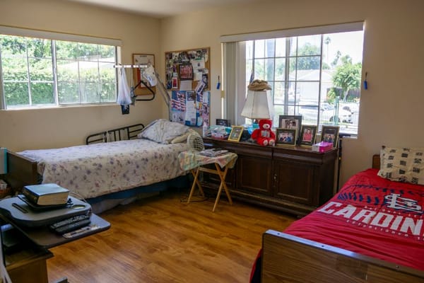 A cozy shared room with two beds and personal decorations