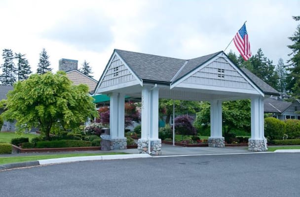 Building entrance with landscaping and American flag