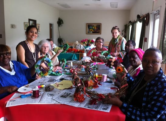 Residents participating in a craft activity, creating decorative wreaths.