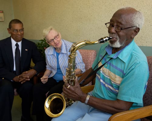 Residents enjoying a music performance indoors