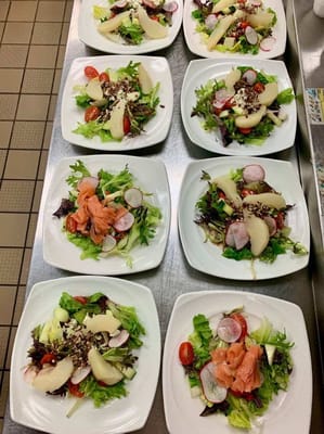 Multiple plates of salads prepared for residents