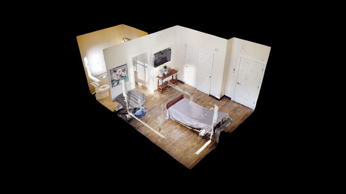 A spacious private room with a bed and furniture