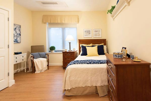 Cozy private resident room with bed and decor