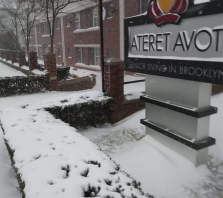 Facility sign in snowy outdoor setting