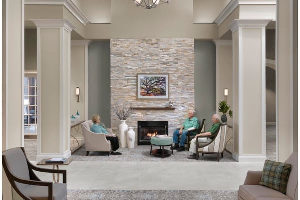 Residents enjoying a cozy common area with a fireplace