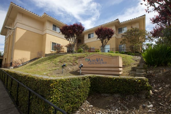 Exterior view of AlmaVia facility with landscaped entrance