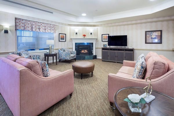 Cozy common room with seating and a fireplace