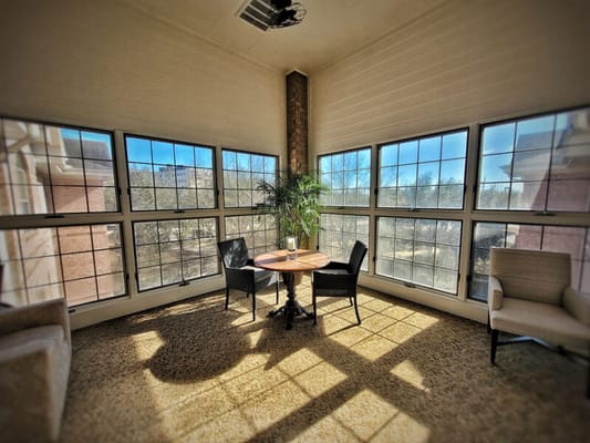 Bright sunlit common area with seating