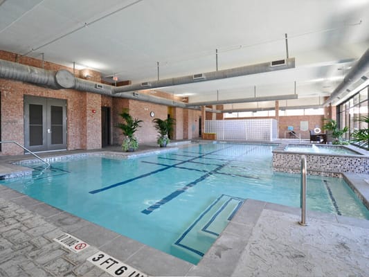 Indoor swimming pool area with lounge chairs