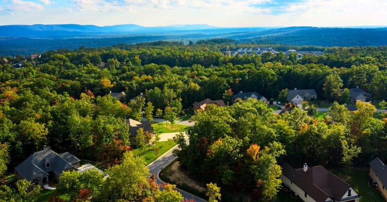 Aerial view of a senior living community surrounded by trees