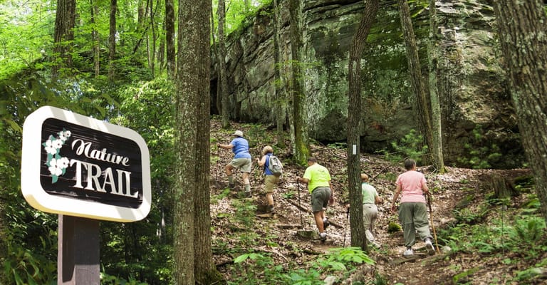 Residents hiking on a nature trail near the facility