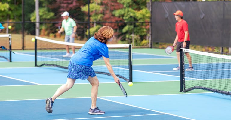 Residents playing tennis on outdoor courts