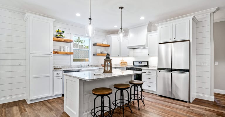 Modern kitchen with white cabinets and island seating