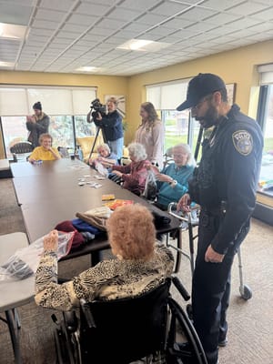 Residents engaging in an activity with staff assistance