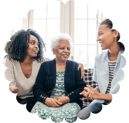 Three women sharing a joyful conversation indoors