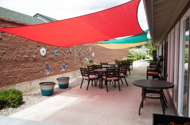 Outdoor patio with shaded seating at South Hill Village