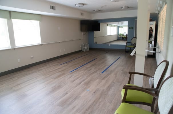 Spacious activity room with chairs and a TV