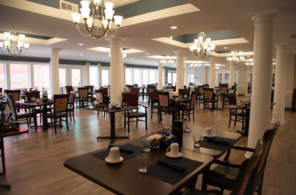 Spacious dining area with tables and chairs in South Hill Village.