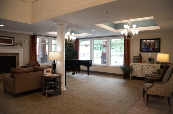 Spacious lobby area with seating, piano, and decorative lighting.