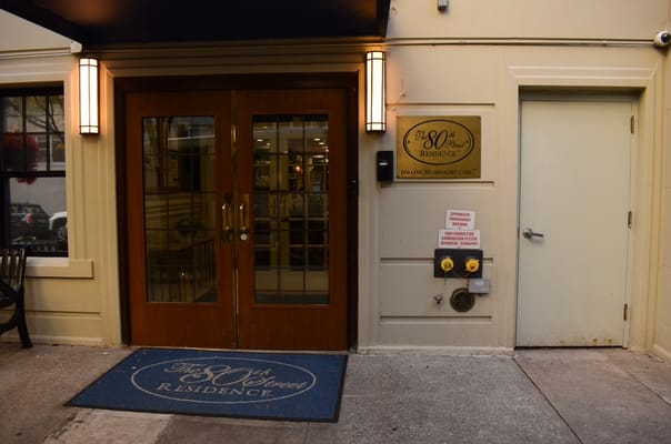 Entrance of the 80th Street Residence with signage