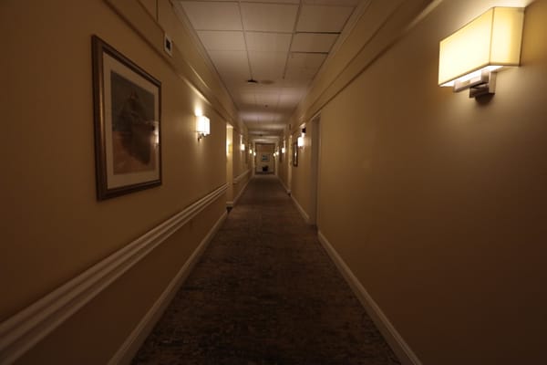 A well-lit corridor in a senior living facility