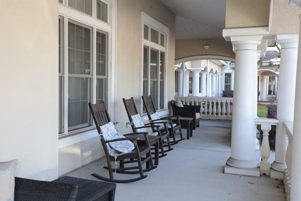 Charming porch with rocking chairs at Sunrise of Jacksonville